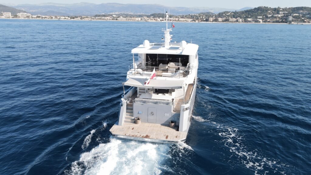 Aegean Explorer motor yacht UK2606 stern view at anchor in a wooded Mediterranean cove