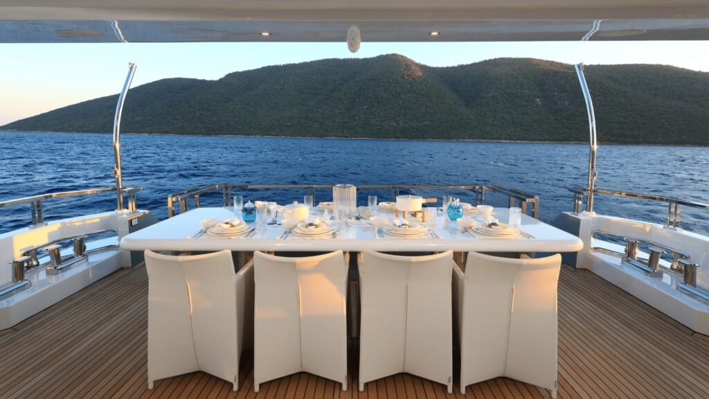 Aft deck alfresco dining table for twelve on Aegean Explorer motor yacht UK2606, Sardinia charter