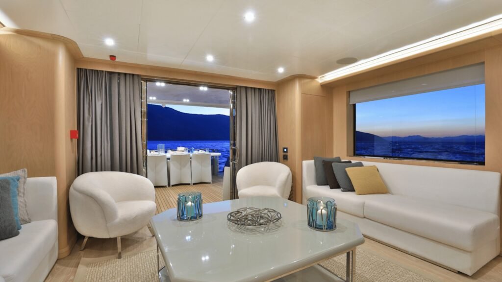 Main saloon lounge with light oak joinery and white sofas aboard Aegean Explorer motor yacht UK2606