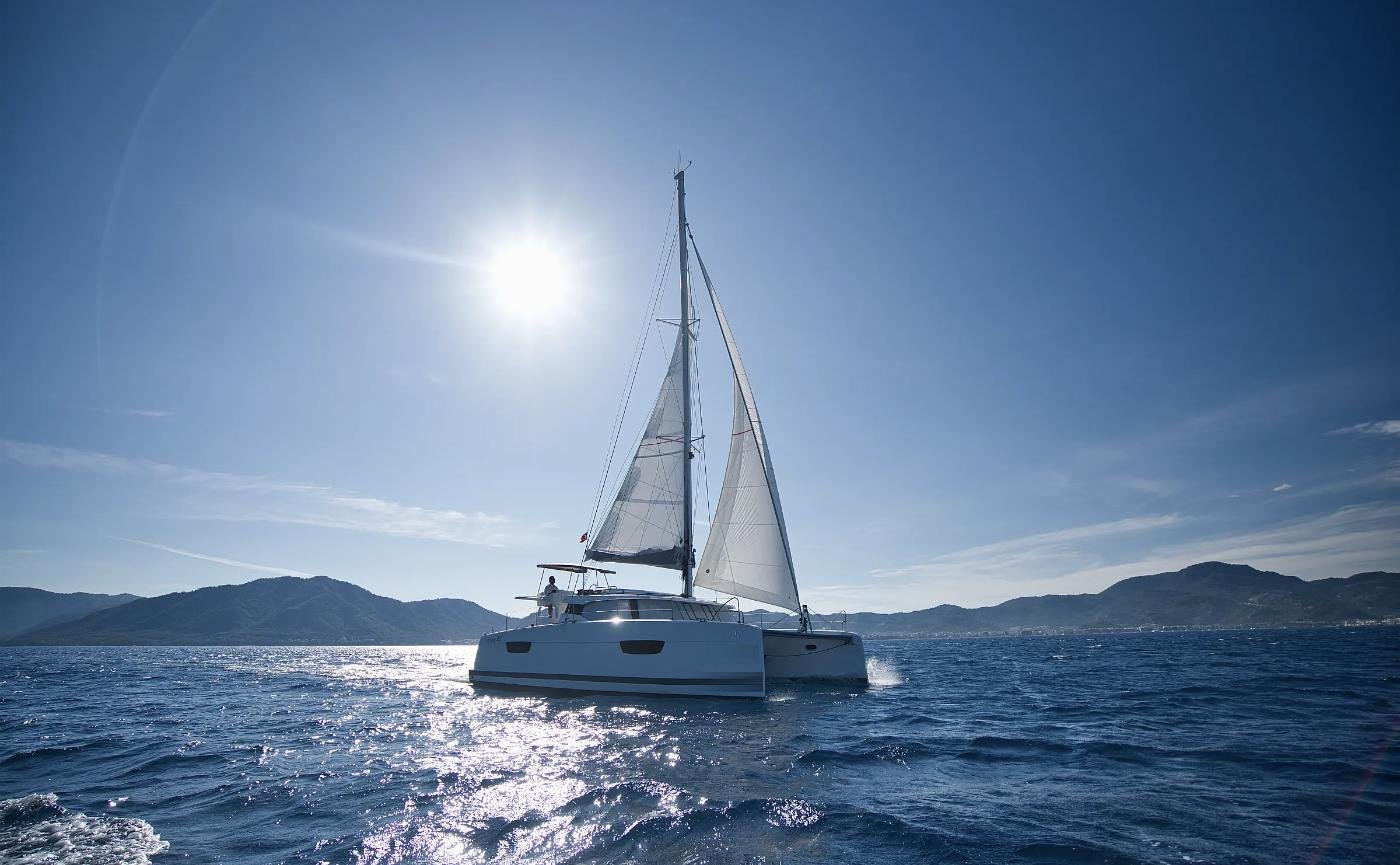 Astrea 42 charter catamaran seen across a calm Marmaris bay with mountains behind