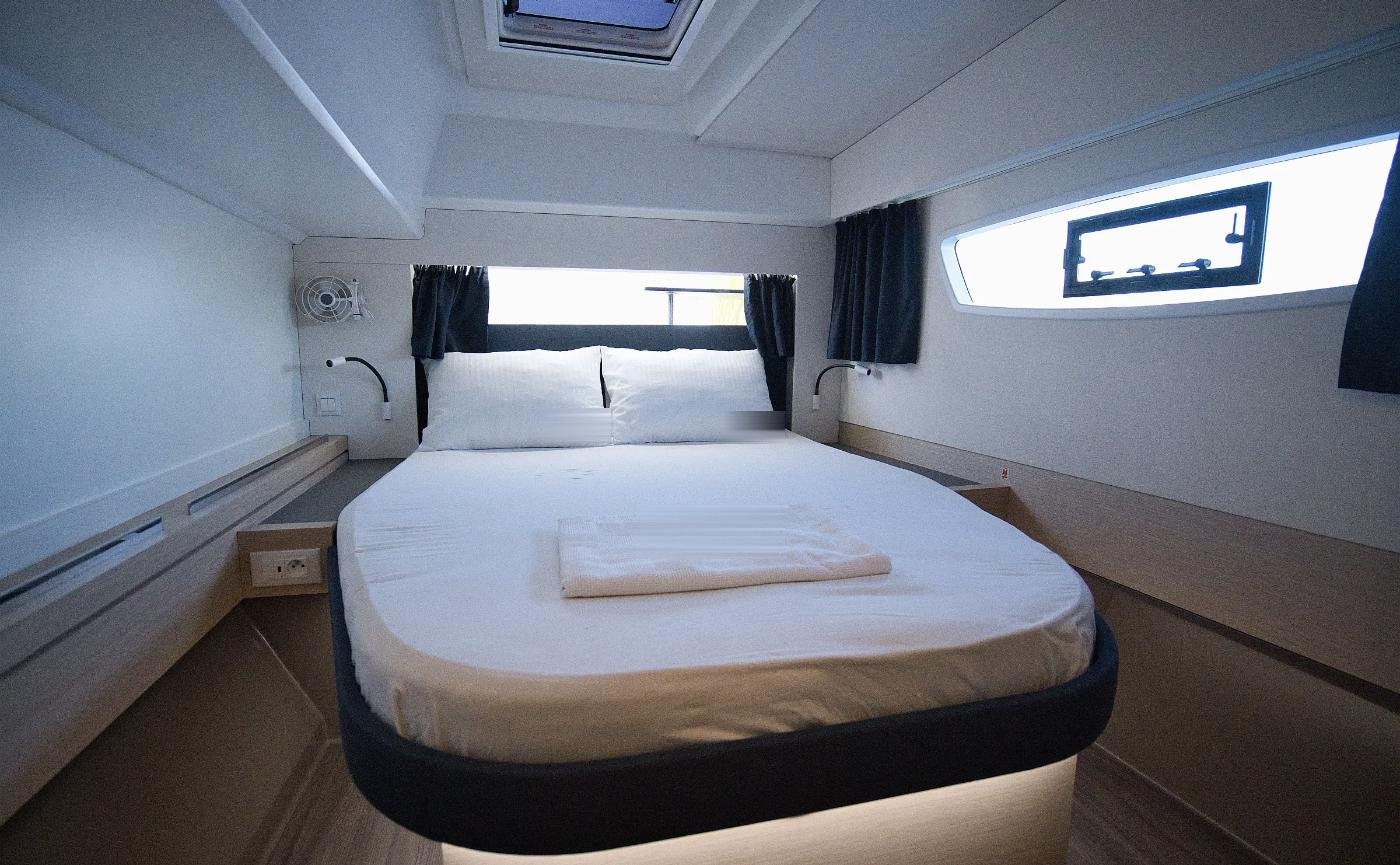 Owner double cabin of the Astrea 42 charter catamaran in Marmaris with hull windows and fresh linen