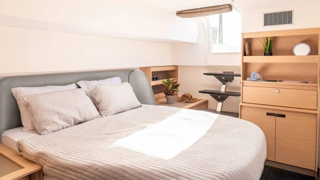 Aura 51 catamaran owner cabin with double berth, headboard and shelving, Rhodes charter AM1604