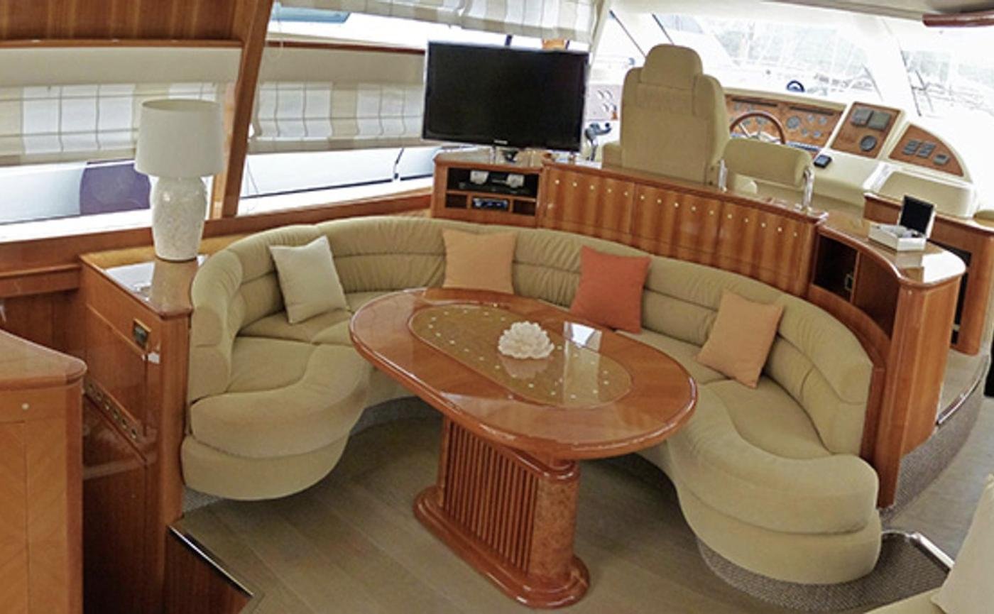 Saloon dining settee and flat-screen television on an Azimut 58 motor yacht