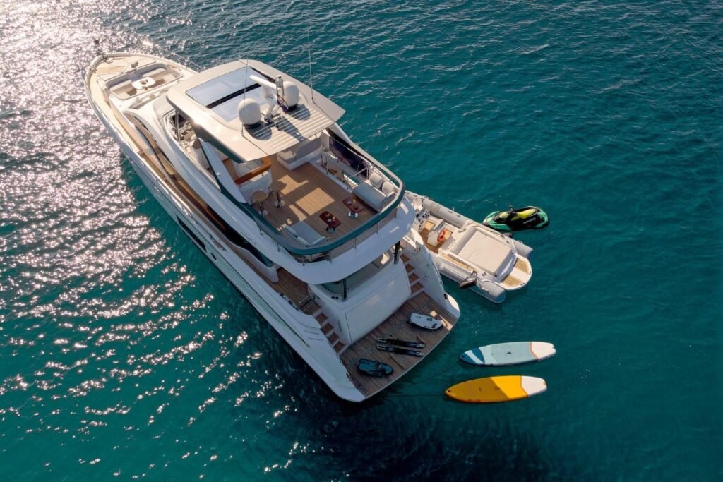 Aerial stern view of Azimut 78 Fly CO2404 with kayaks and paddleboards in the water, Split motor yacht charter