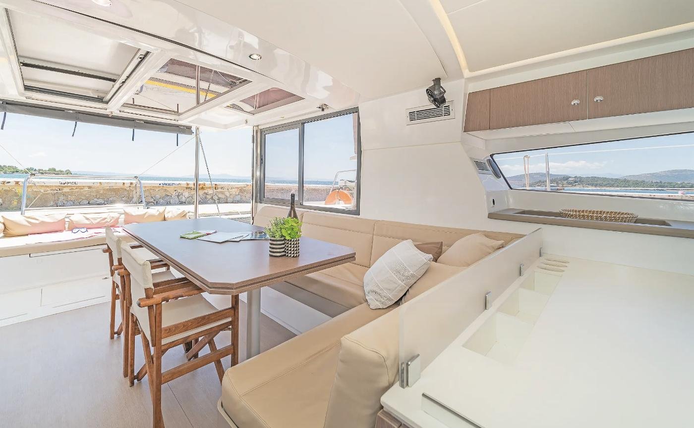 Saloon and dining table of a Bali 4.1 charter Rhodes catamaran