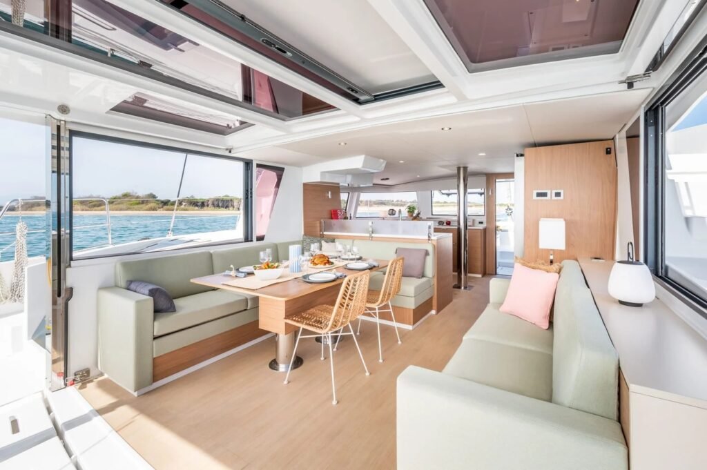 Bali 4.6 catamaran saloon dining and lounge with the tilting aft door raised, Rhodes charter LE1406