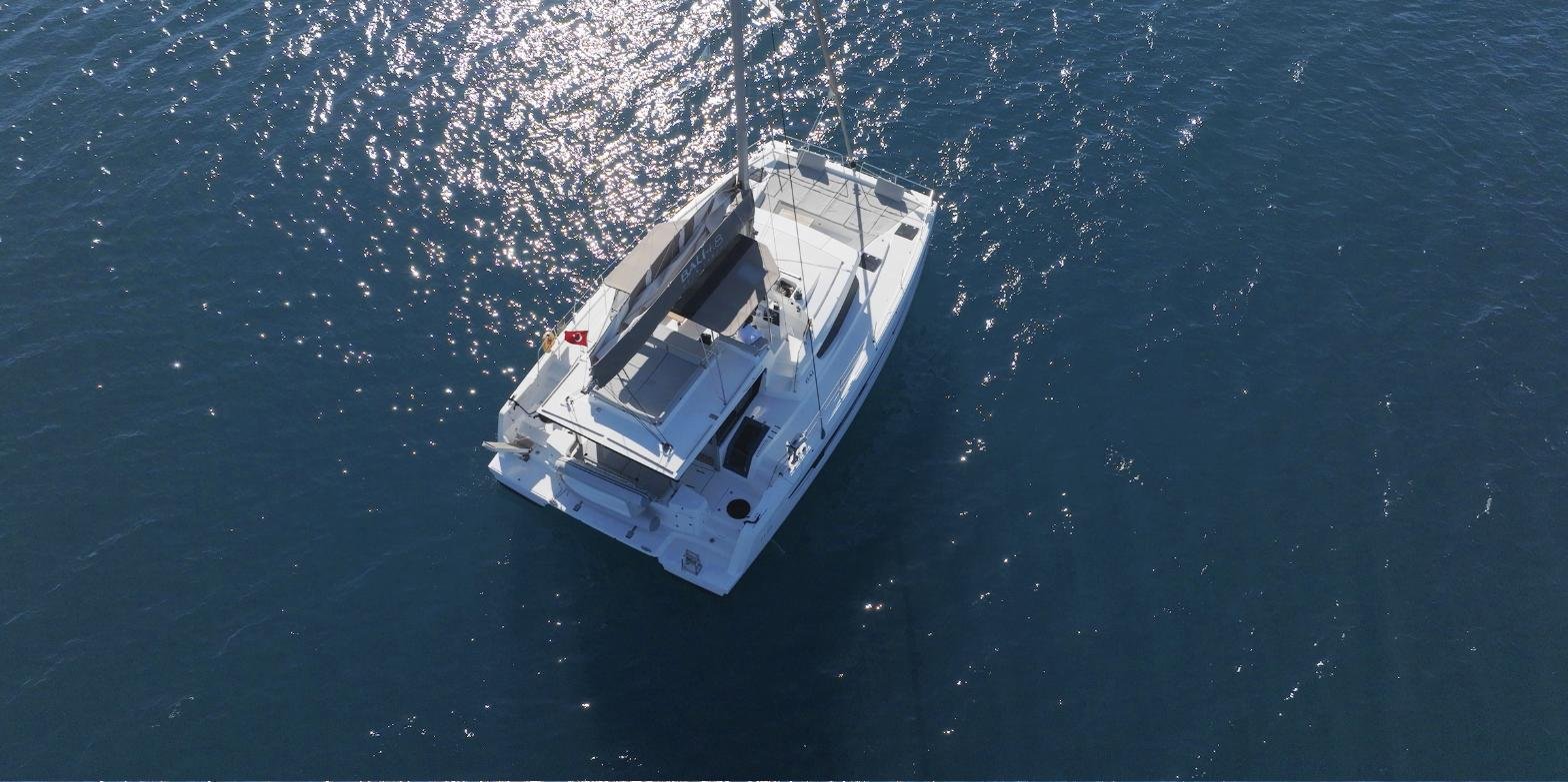 Bali 4.8 charter Marmaris - drone view of the 15m catamaran anchored on open blue water