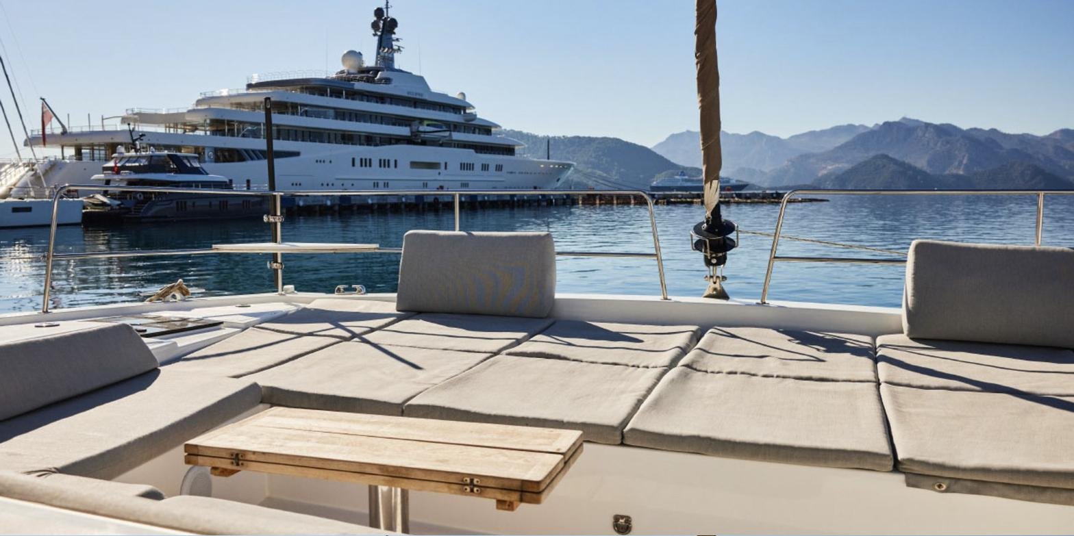 Bali 4.8 charter Marmaris - forward cockpit sunpads and folding table looking over the bay