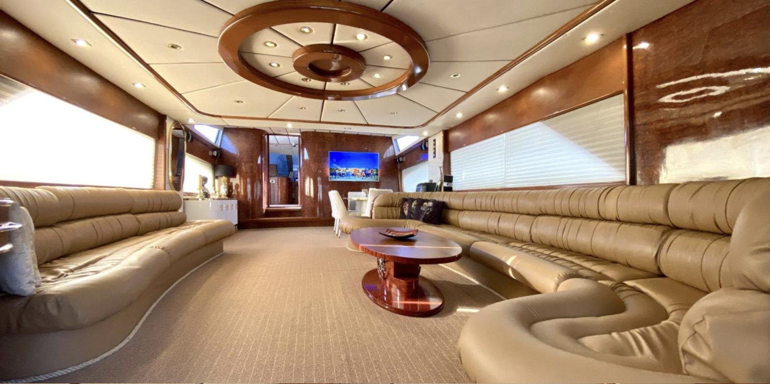 Main saloon with leather seating and burl panelling on a 32m Bilgin
