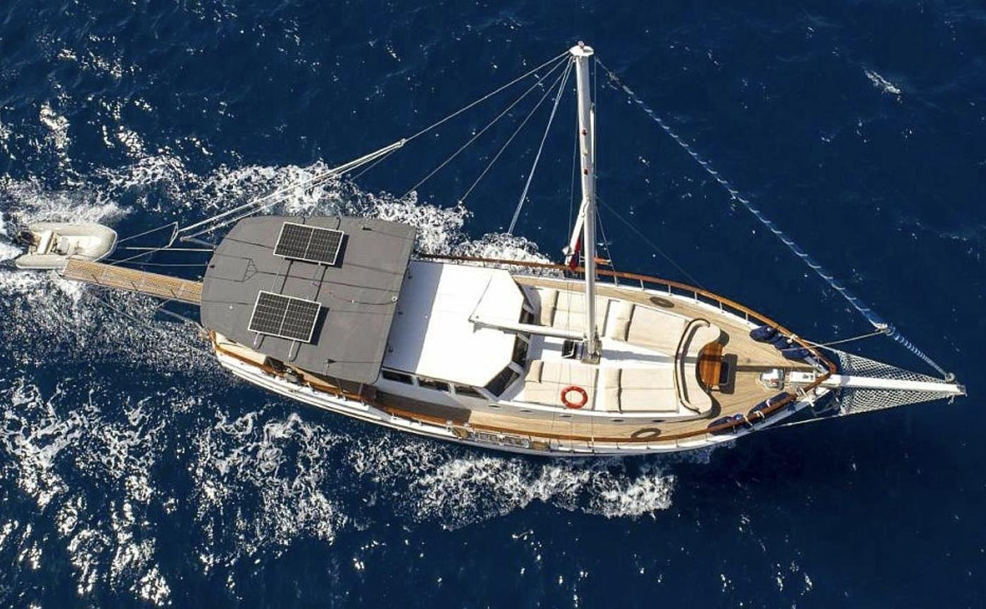 Boutique gulet charter Bodrum - drone view of the gulet under way with her tender astern