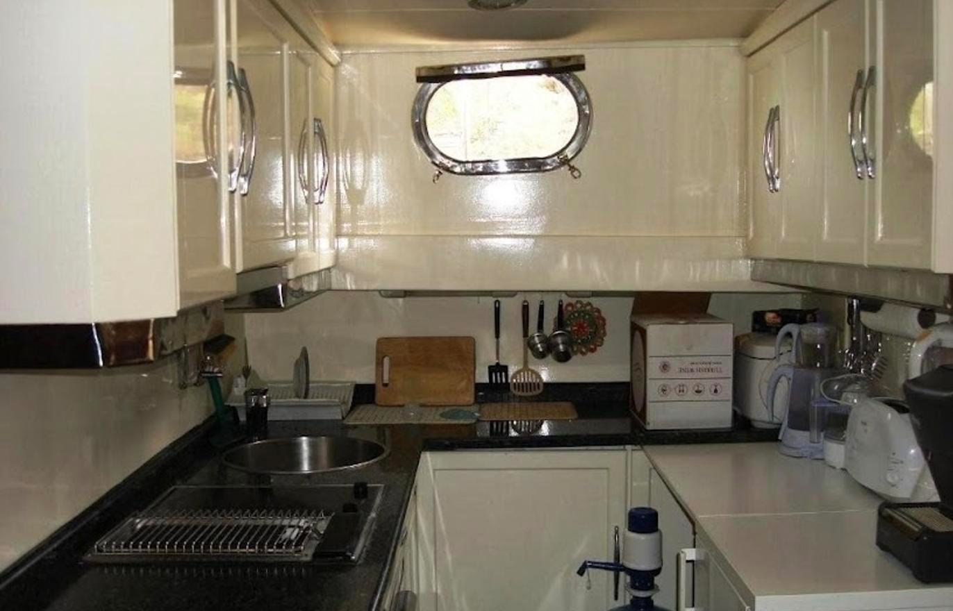 Boutique gulet charter Fethiye - galley with granite worktops and brass portlight