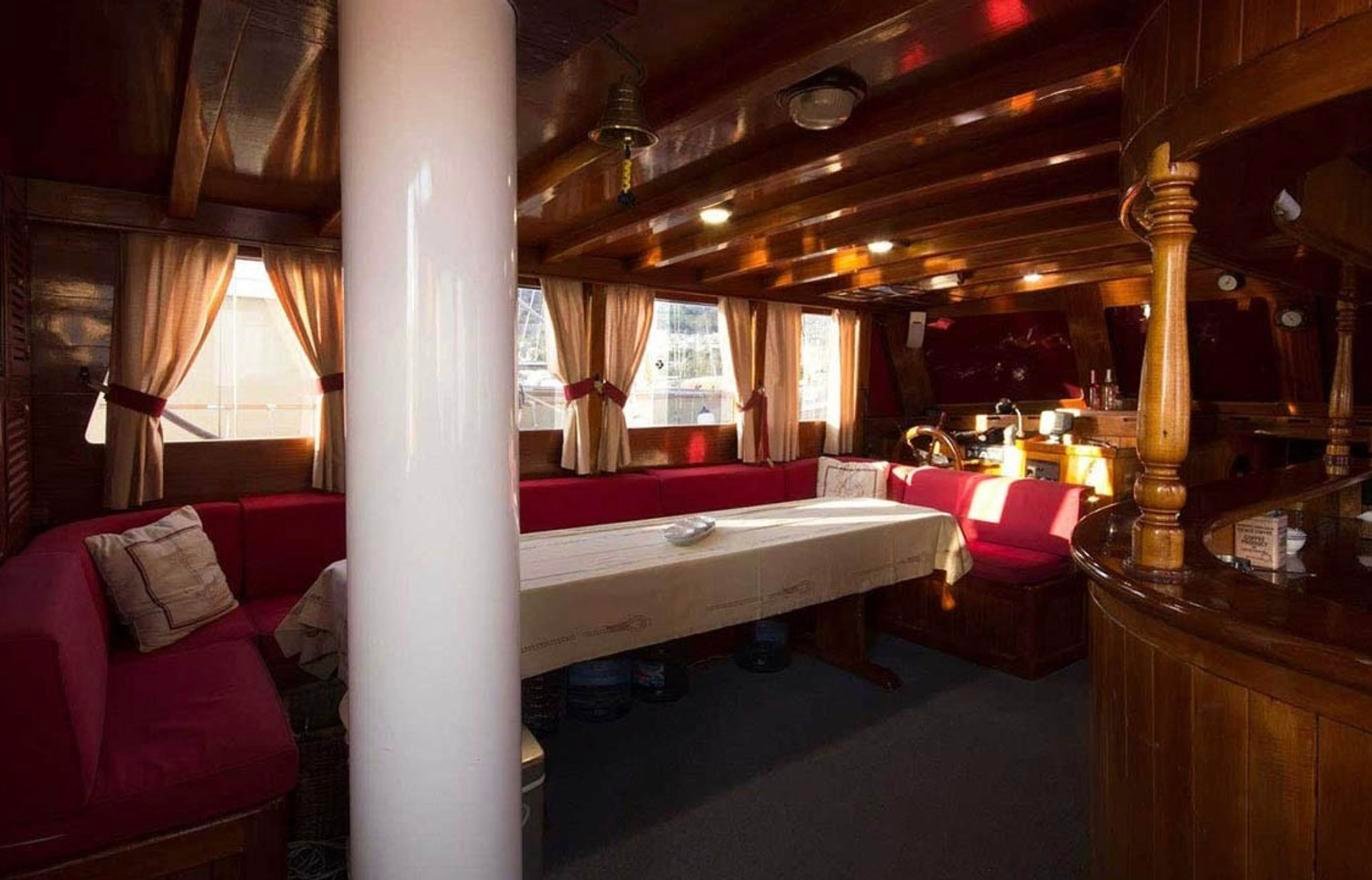 Main saloon with long dining table on a classic gulet charter Marmaris