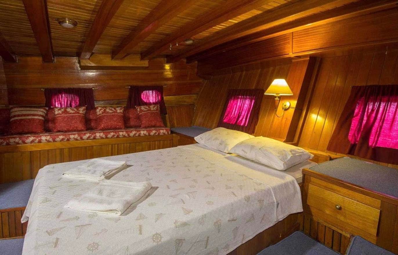 Double cabin with day settee and portlights aboard a 24m Turkish gulet