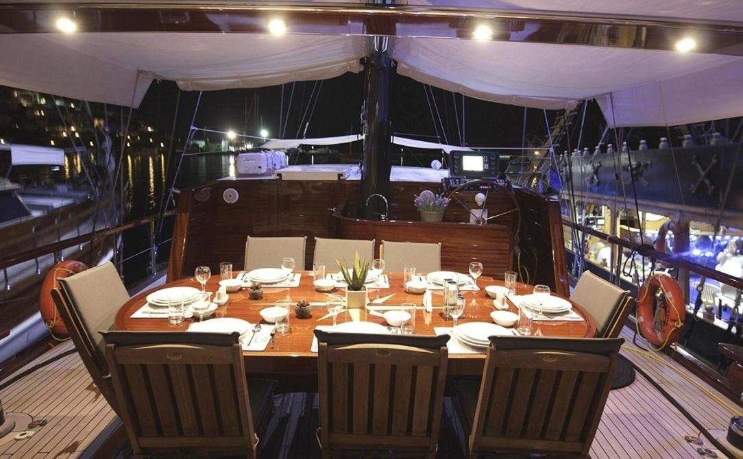 Contemporary gulet charter Bodrum - aft deck dinner setting after dark