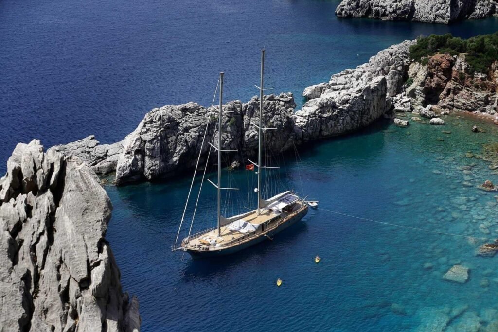 Deluxe motor sailer charter Bodrum SM3610 anchored in a turquoise cove