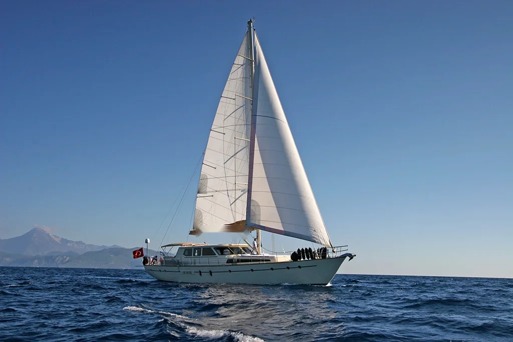 TC2608 26m crewed sailing yacht charter Bodrum sailing with mountain backdrop