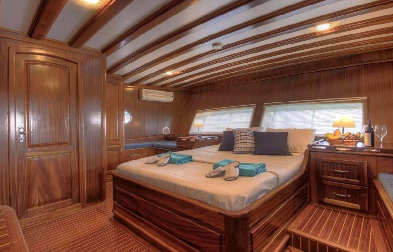 Master double cabin with hull windows on a deluxe gulet charter Fethiye