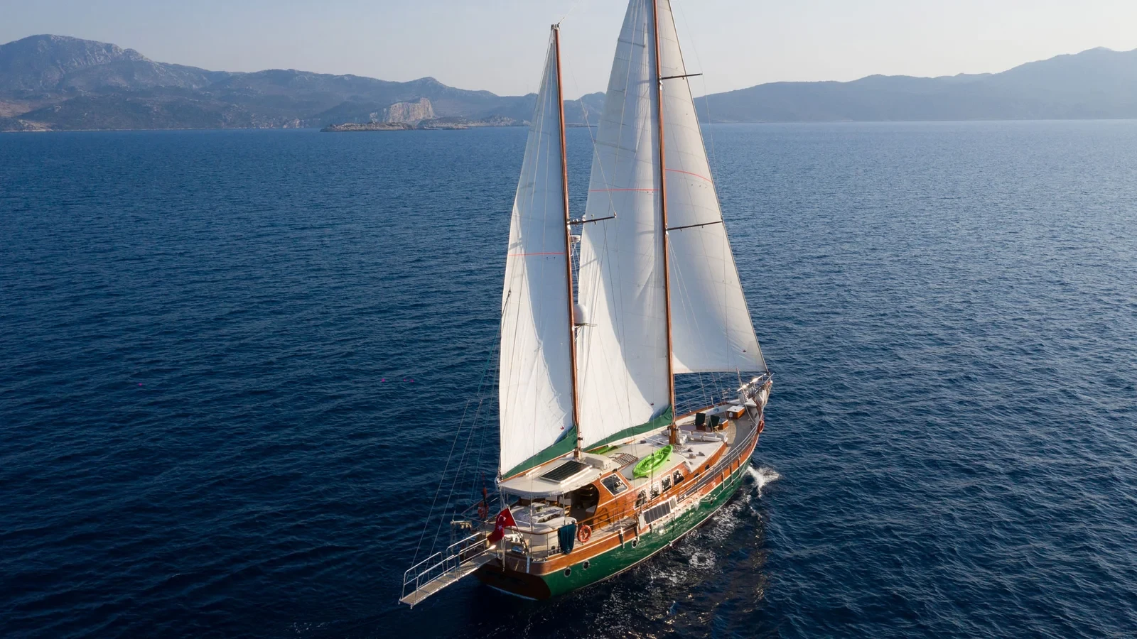 LF2308 23m deluxe gulet charter Rhodes full sail aerial coastal cruise