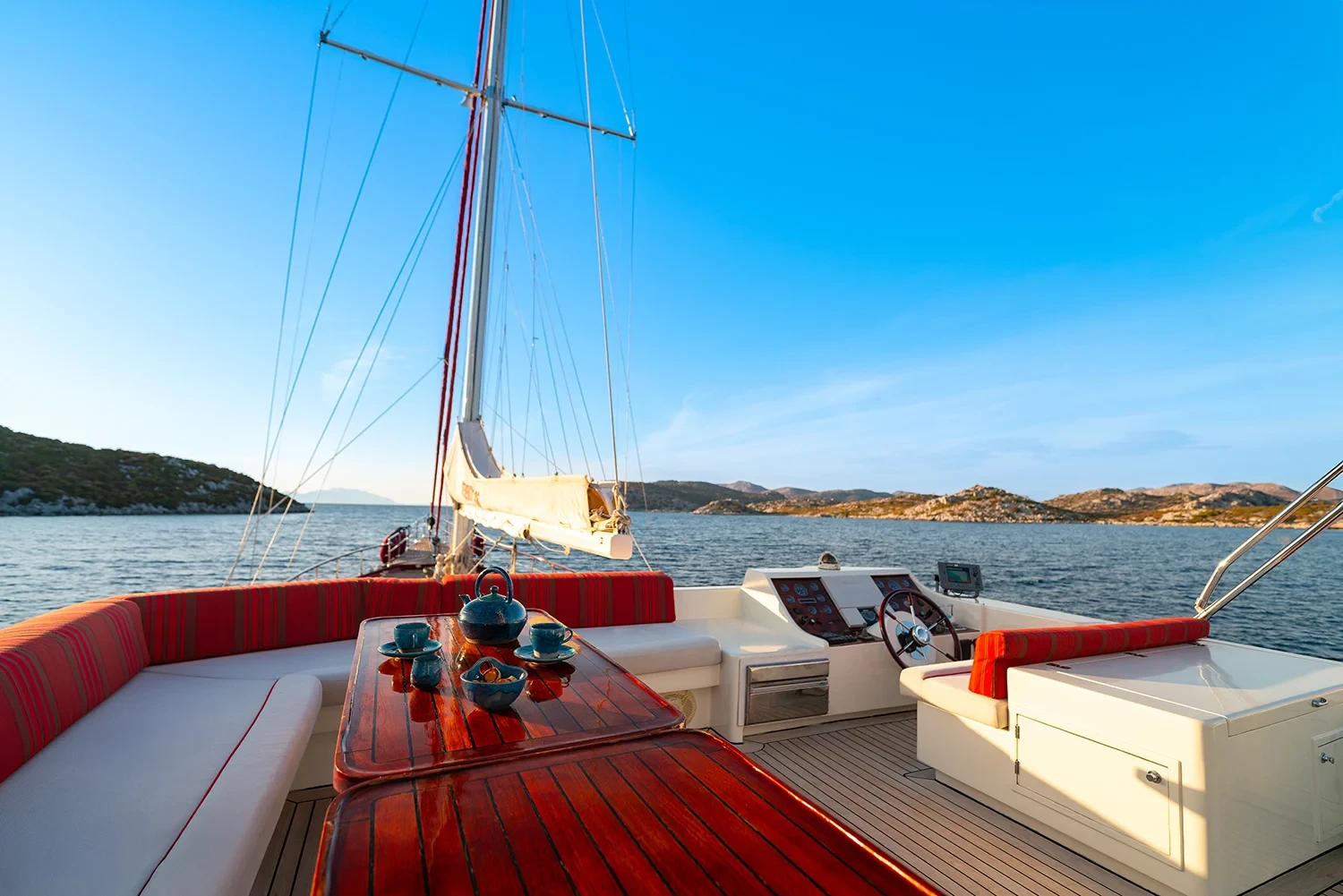 Deluxe motor sailer charter Gocek aft deck lounge seating with teak dining table
