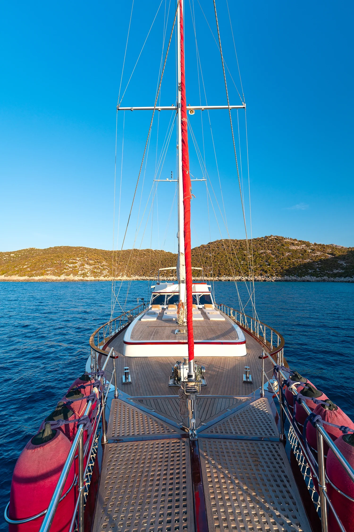 Deluxe motor sailer charter Gocek foredeck view forward underway with rigging against the sky