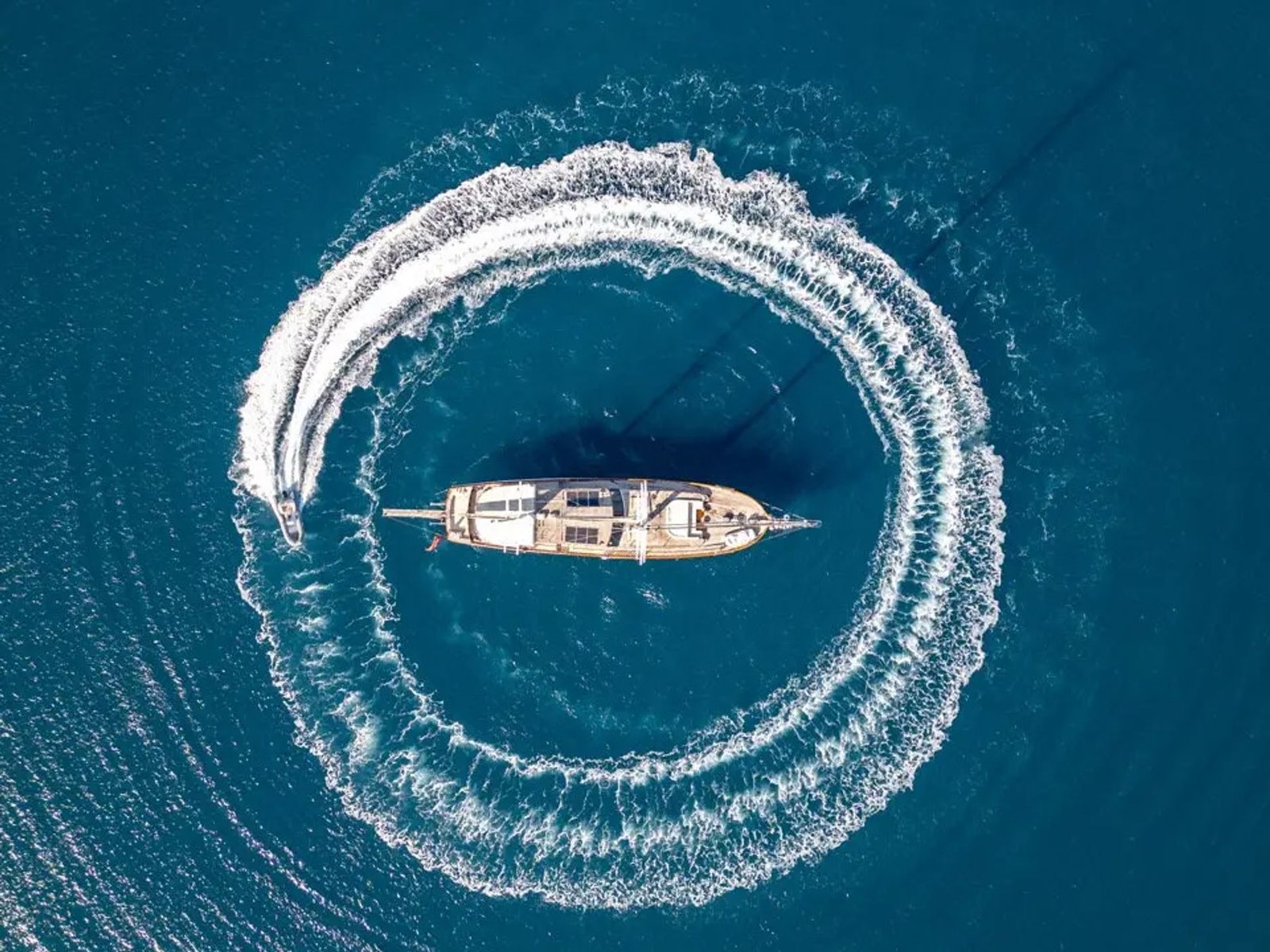 Motor sailer charter Bodrum under drone view in Bodrum Bay, Turkey