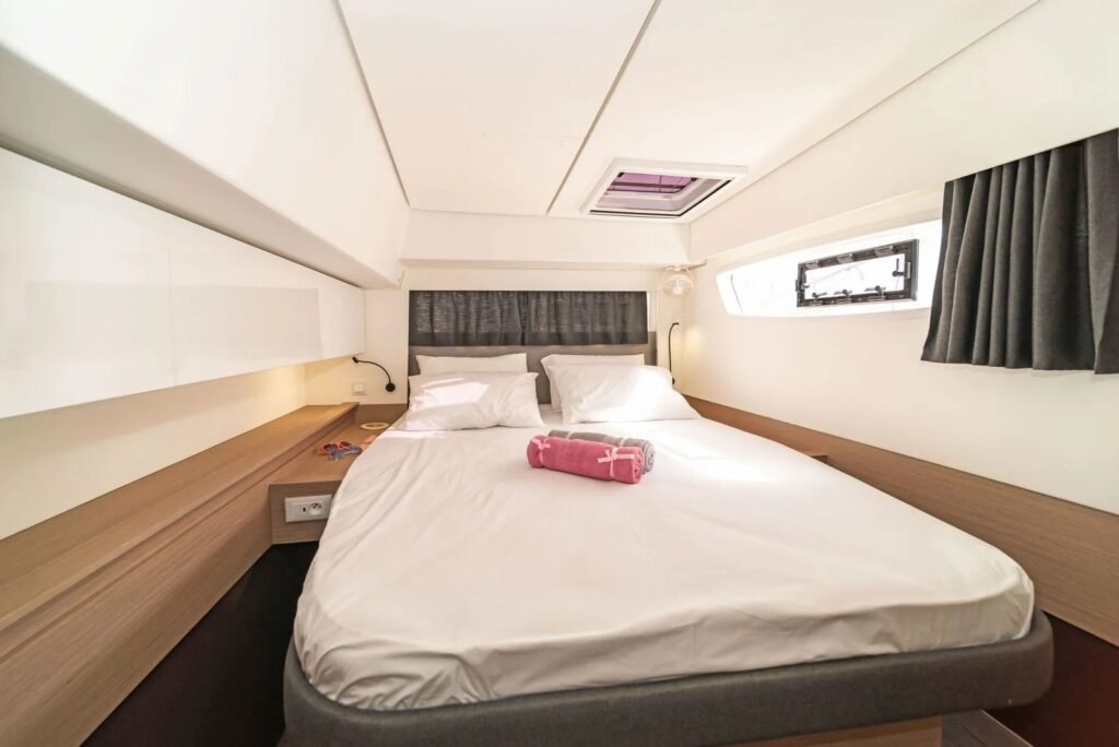 Elba 45 catamaran double guest cabin with island berth and hull window, Kos charter NB1306