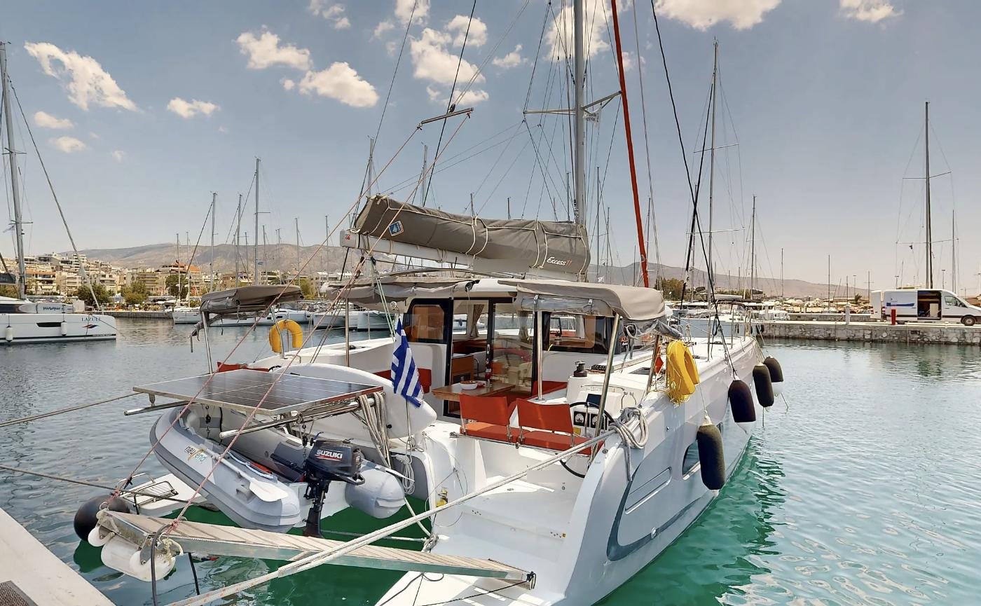 Stern quarter of an Excess 11 charter catamaran with tender and solar panel
