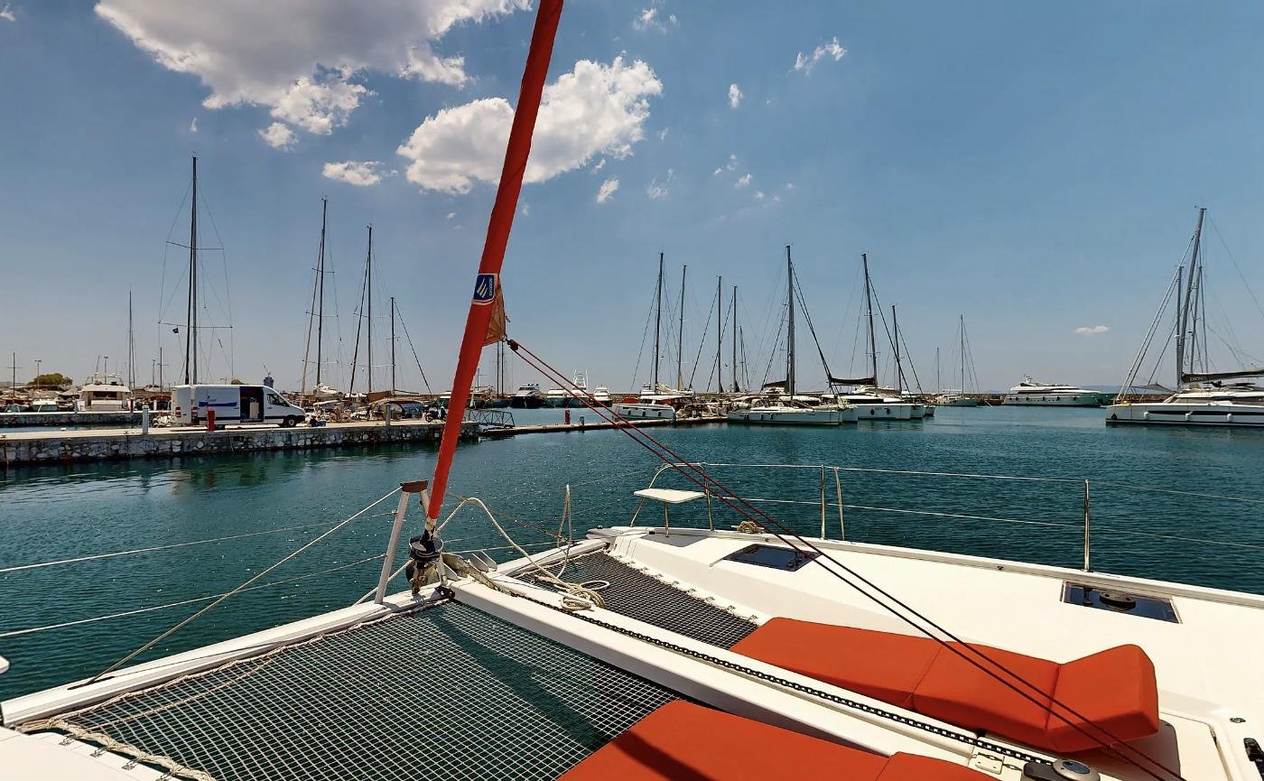 Foredeck of an Excess 11 catamaran looking over the harbour