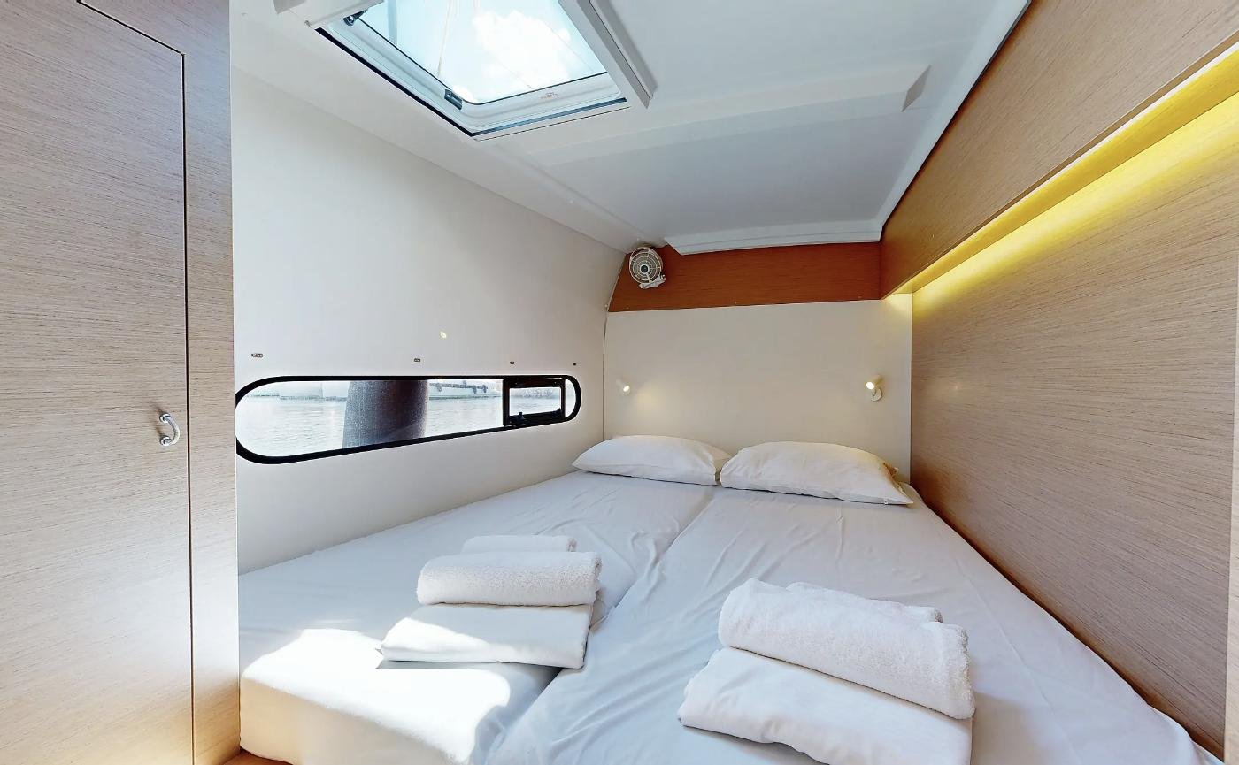 Forward double cabin with hull window on an Excess 11 charter Rhodes catamaran