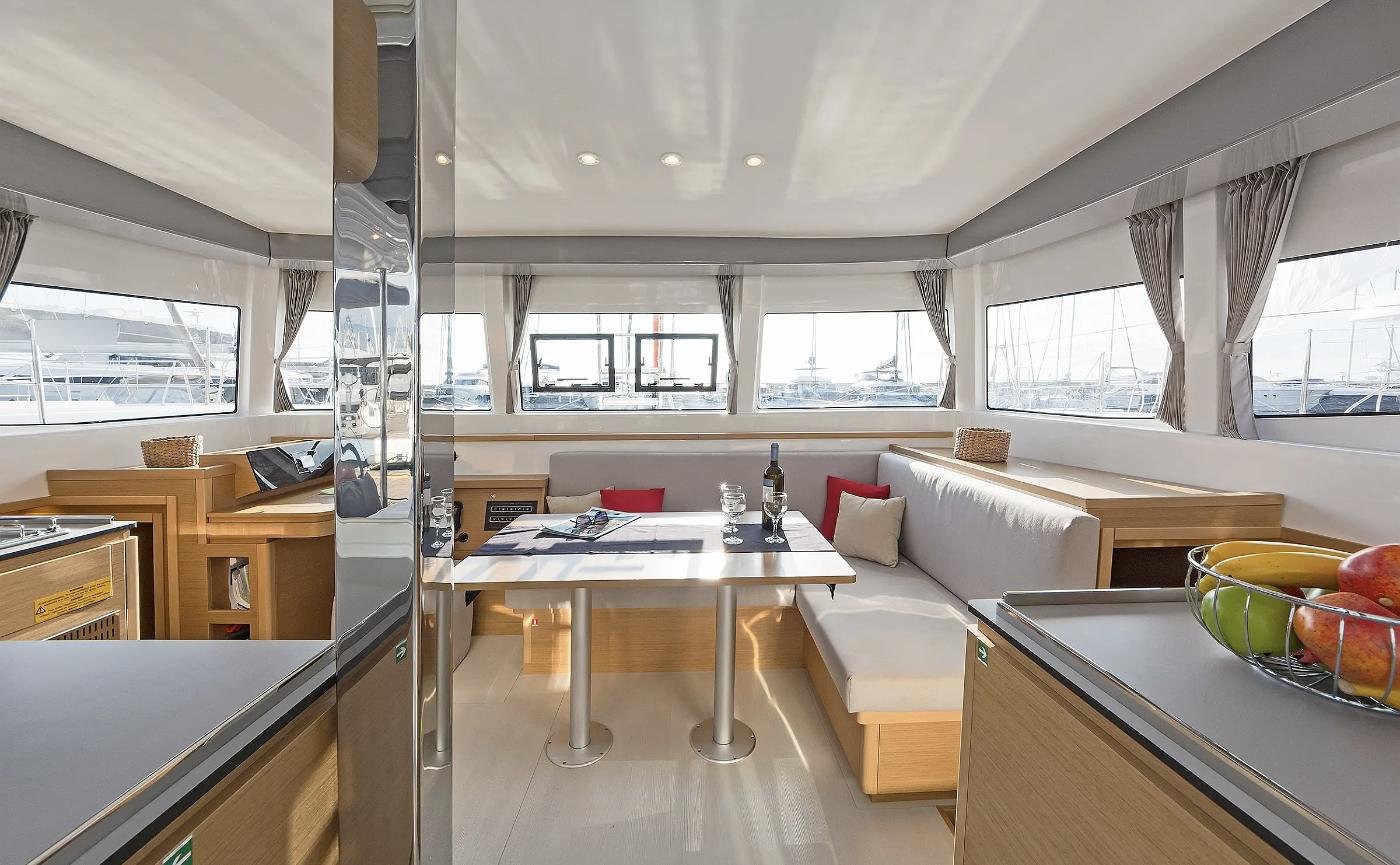 Saloon dining settee and panoramic windows on an Excess 12 charter Kos catamaran