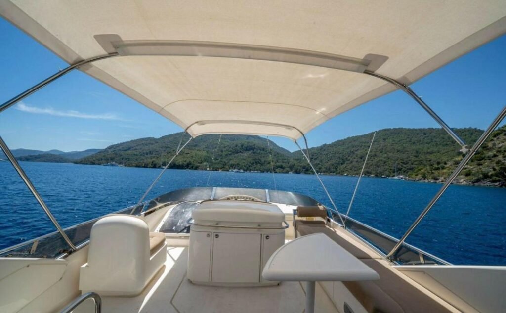 Fairline 59 charter Göcek — flybridge helm and shaded seating