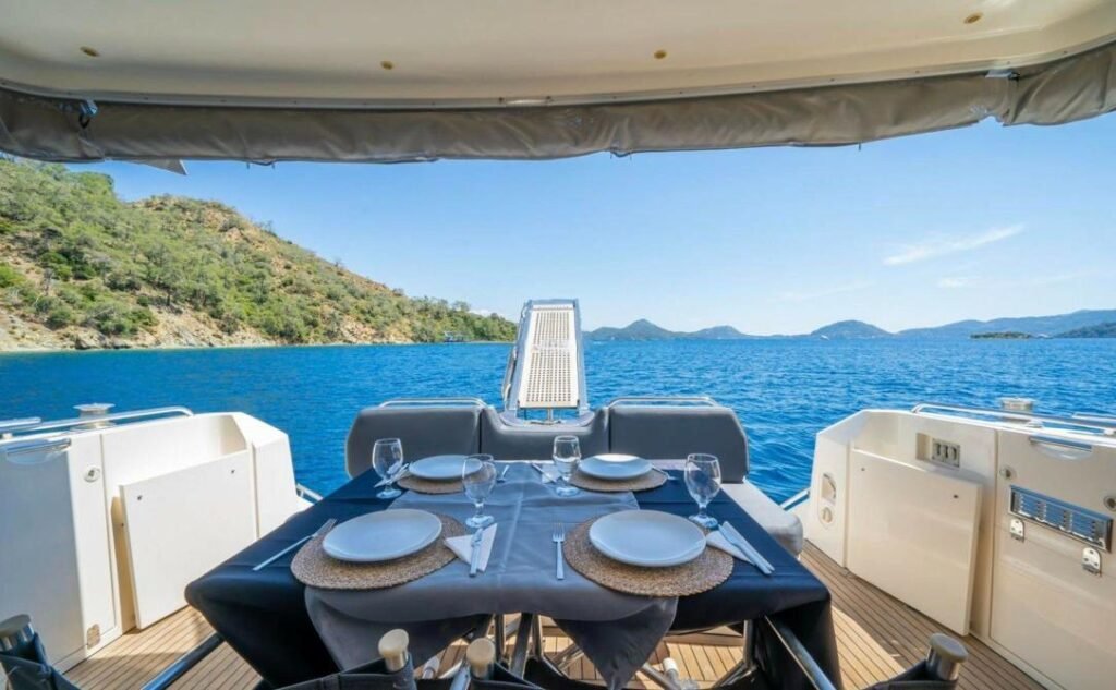 Fairline 59 charter Göcek — aft deck dining table with a sea view