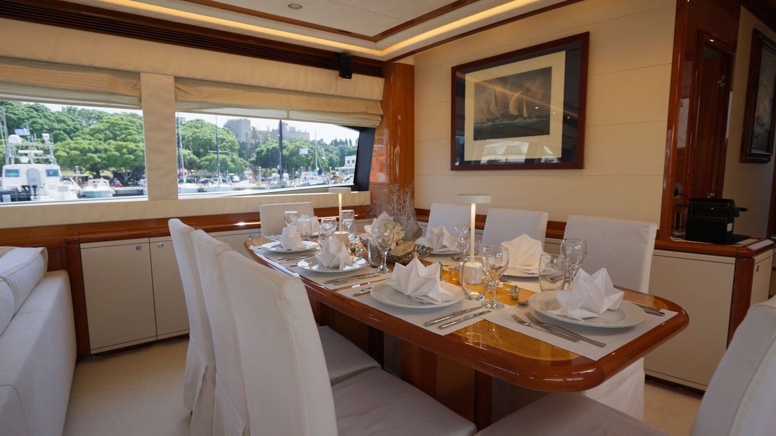 Formal dining table set for eight in the saloon of a Ferretti 830 Fly charter Rhodes