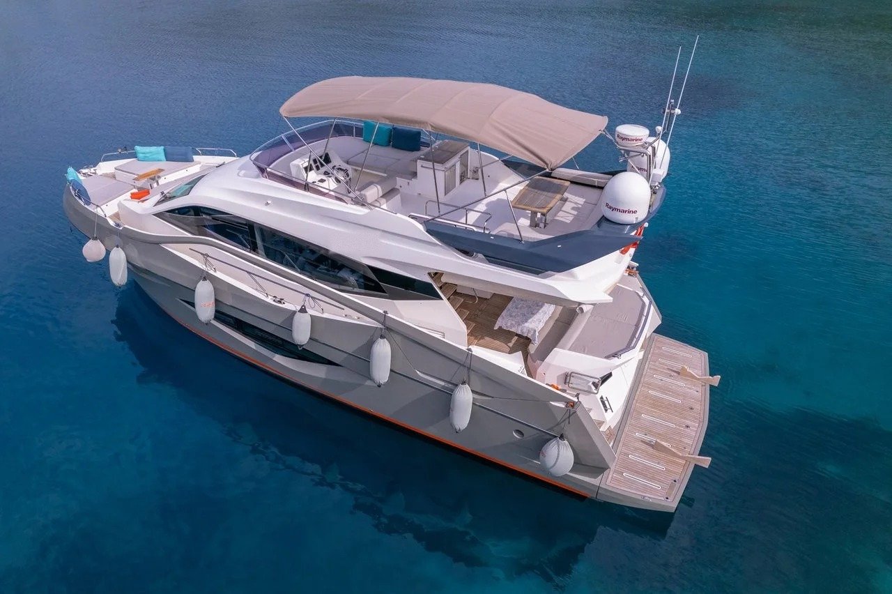 Aerial drone view of the flybridge deck and sundeck of a luxury motor yacht charter