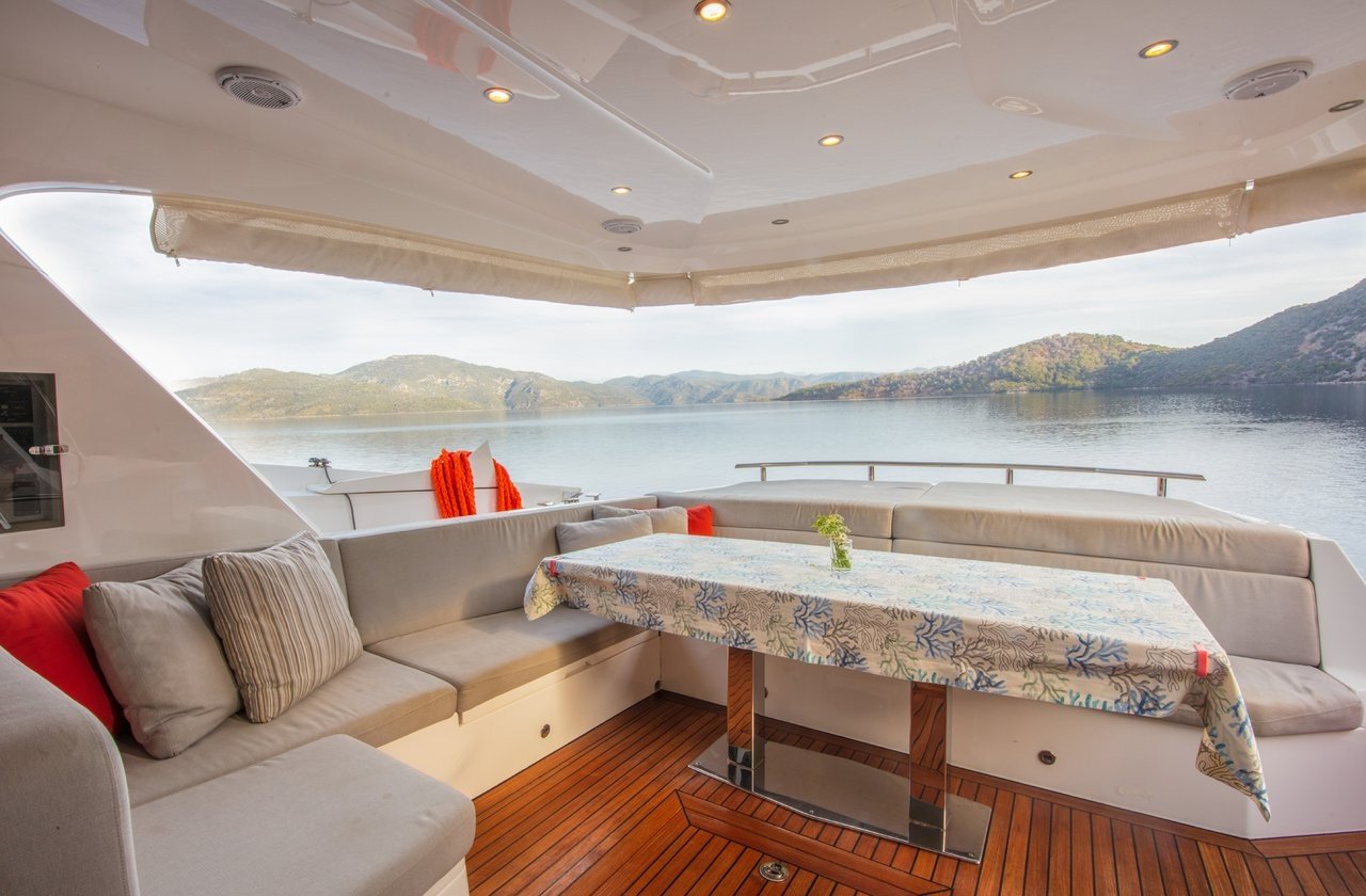 Interior dining and lounge area aboard a flybridge motor yacht charter in Göcek, Turkey