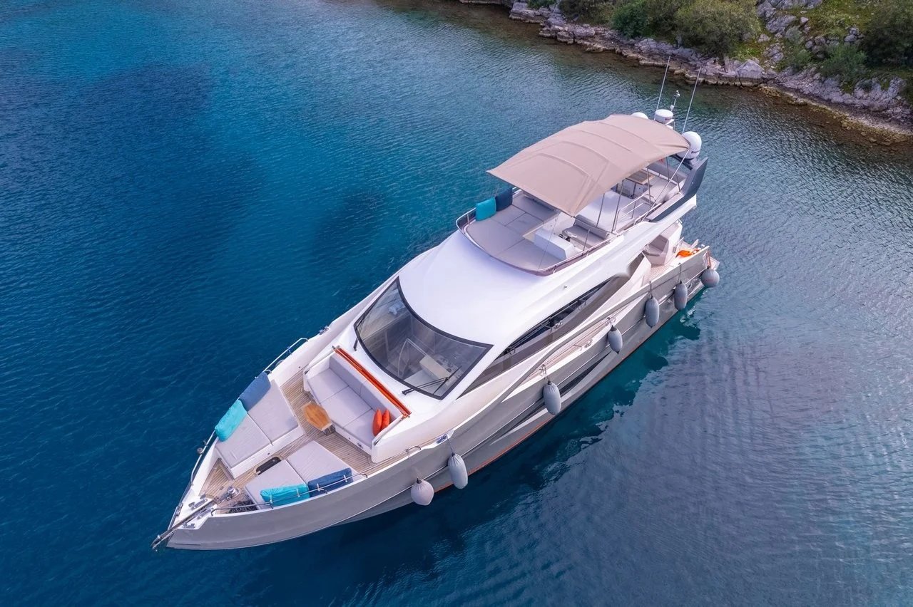 Side profile of a flybridge motor yacht underway off the Turkish coast