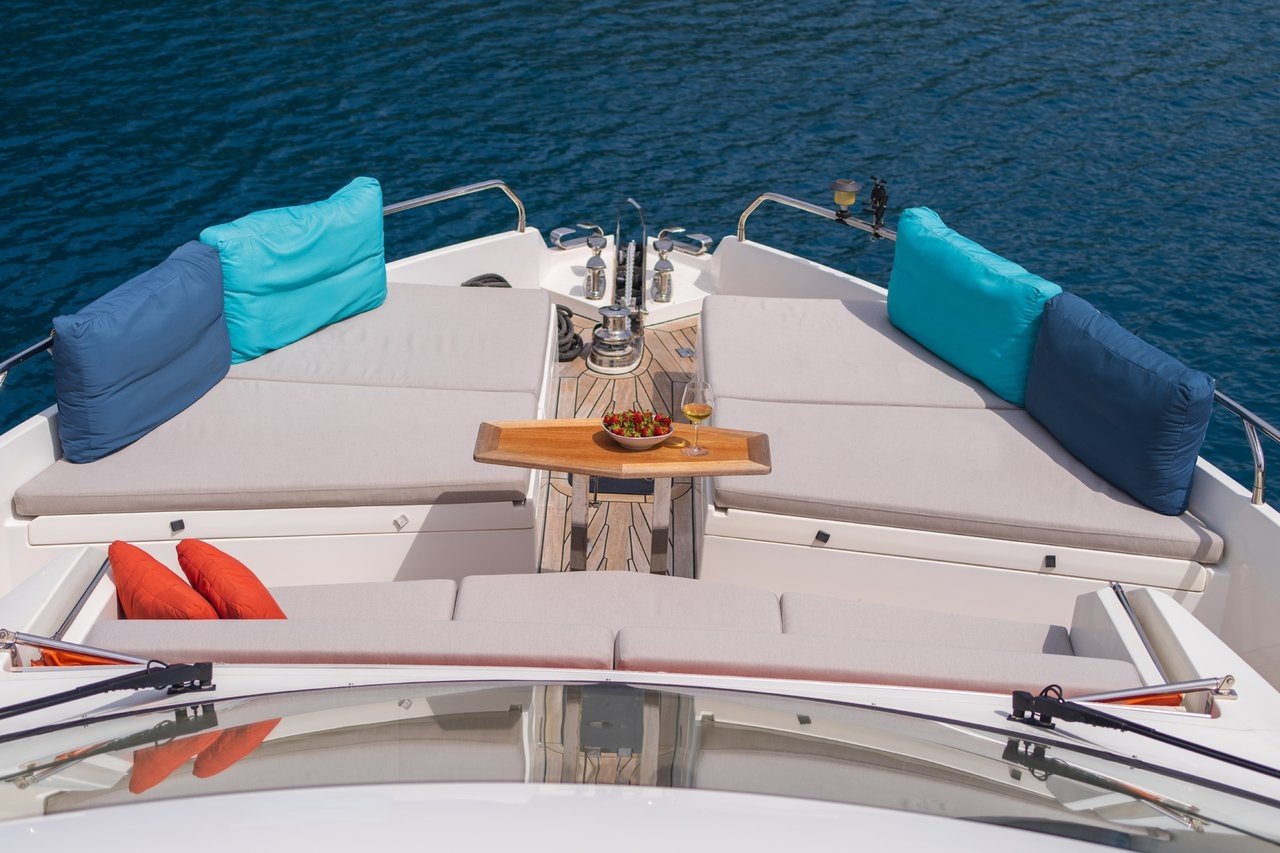 Foredeck sunpad and lounge seating aboard a flybridge motor yacht charter in Göcek