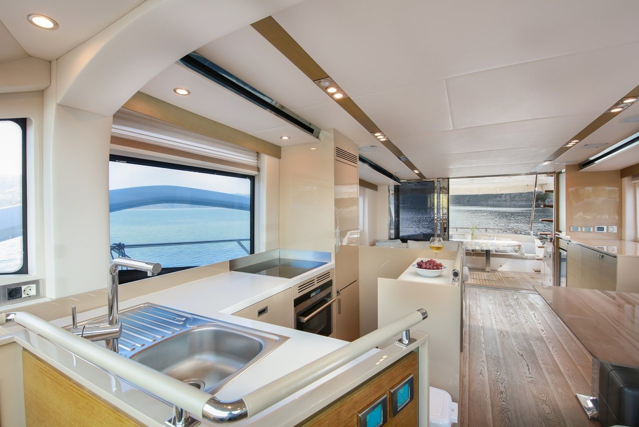 Galley and helm station aboard a flybridge motor yacht charter with sea views