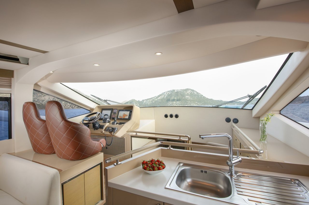 Galley sink and worktop aboard a flybridge motor yacht charter with panoramic windows