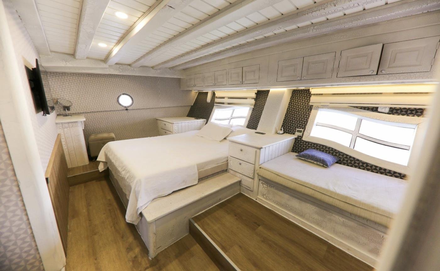 Master cabin with double berth, day bed and hull windows on the Bodrum gulet charter