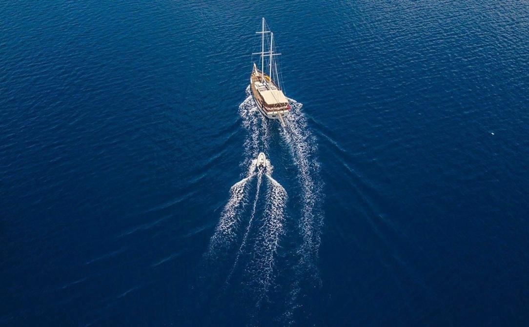 Intimate gulet charter Bodrum - high drone view of the gulet and her wake