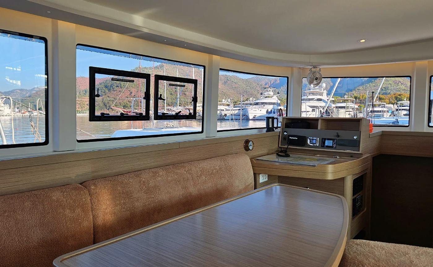 Saloon of the Lagoon 42 catamaran charter yacht in Marmaris with panoramic windows and navigation station
