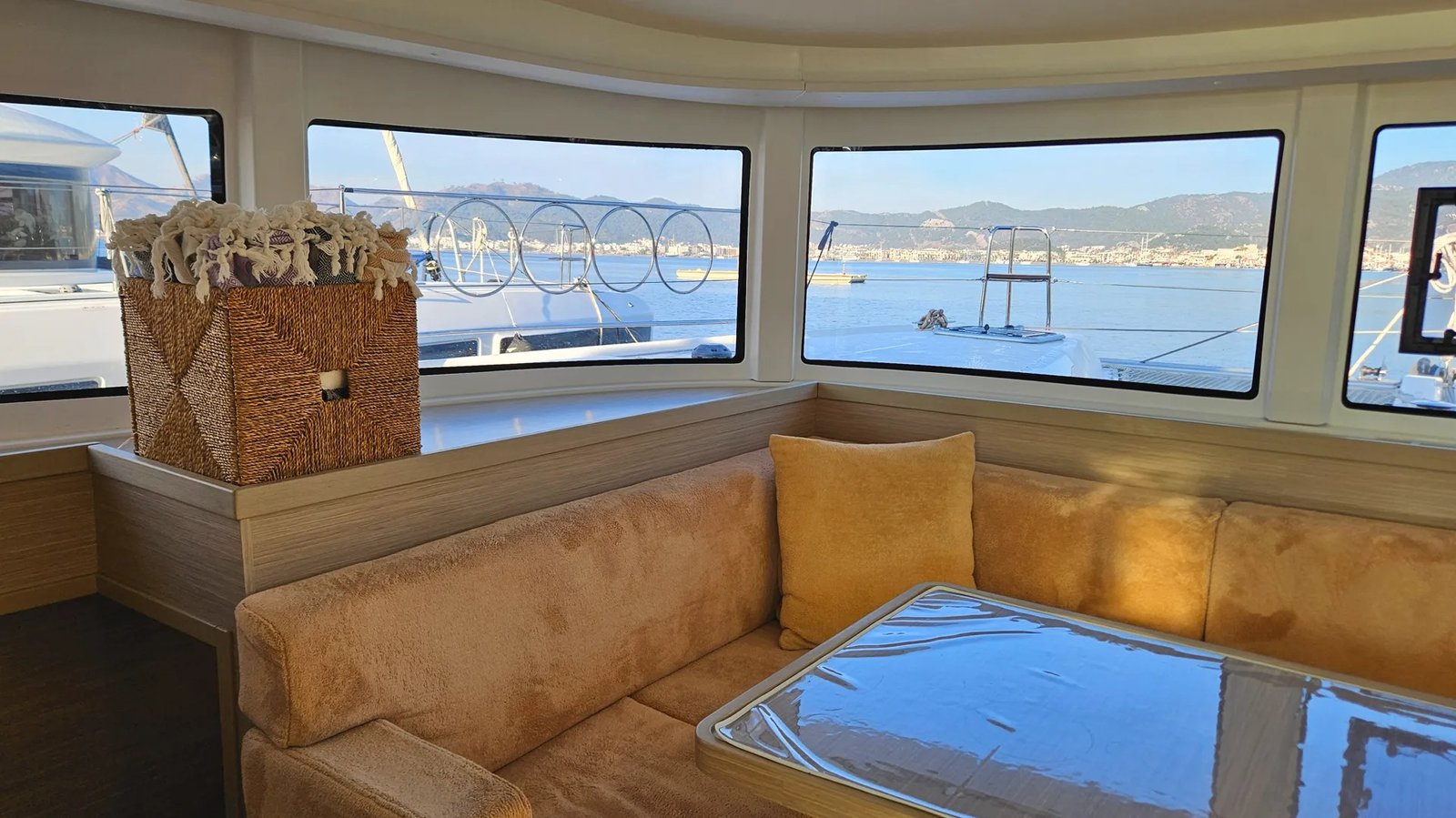 Lagoon 42 catamaran charter Marmaris cockpit lounge seating area with panoramic marina and mountain views