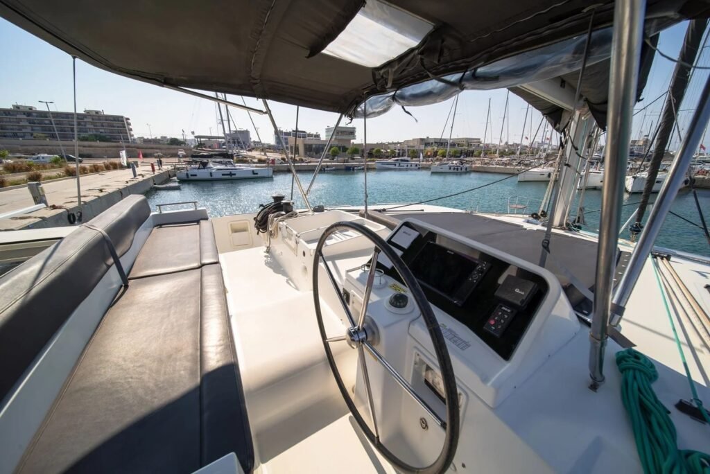 Flybridge helm station with chartplotter and bench seating on Lagoon 450 F catamaran TH1406