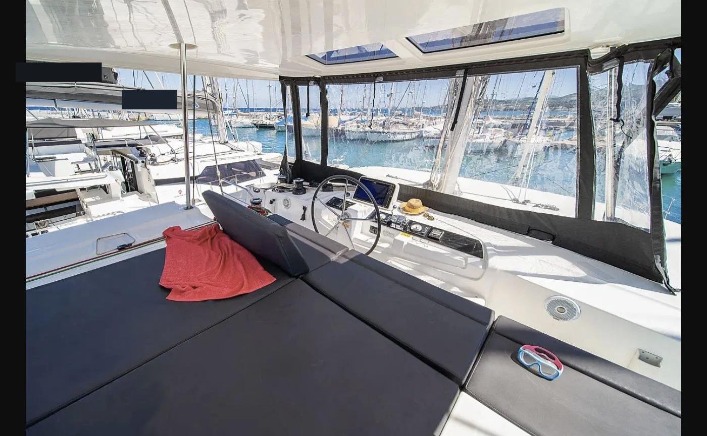 Lagoon 46 catamaran charter Kos — flybridge helm station and lounge seating
