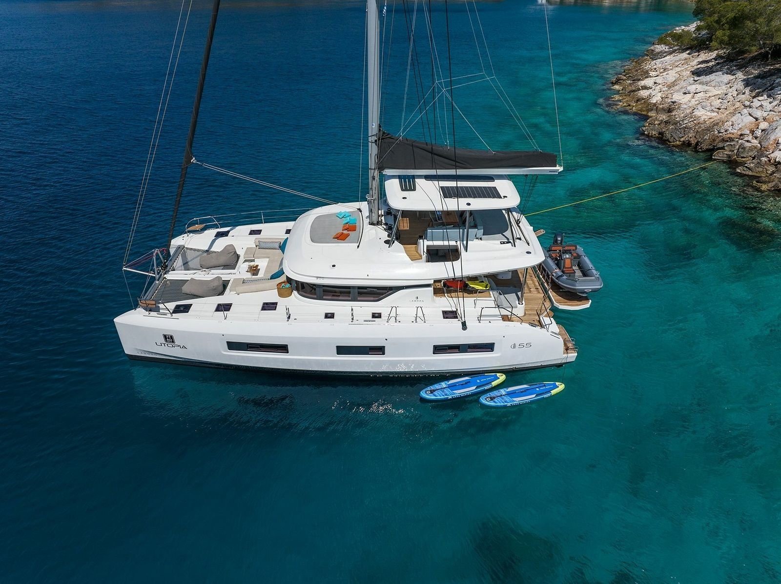 Aerial view of a Lagoon 55 catamaran charter Kos at anchor in clear water