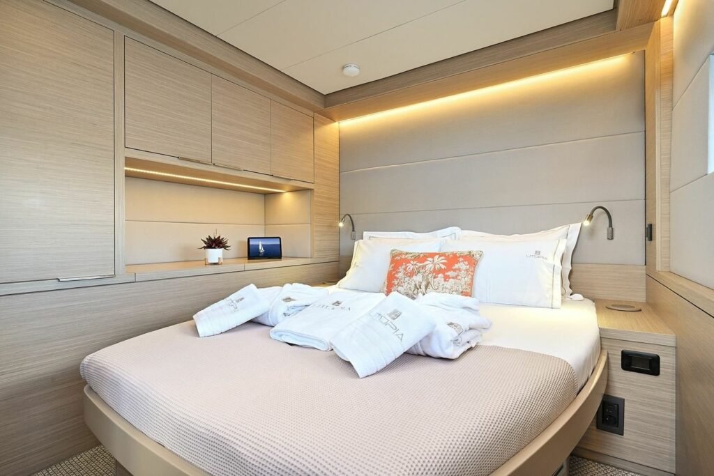 Lagoon 55 catamaran owner suite with double berth, desk, library shelving and hull windows, Kos charter UT1704