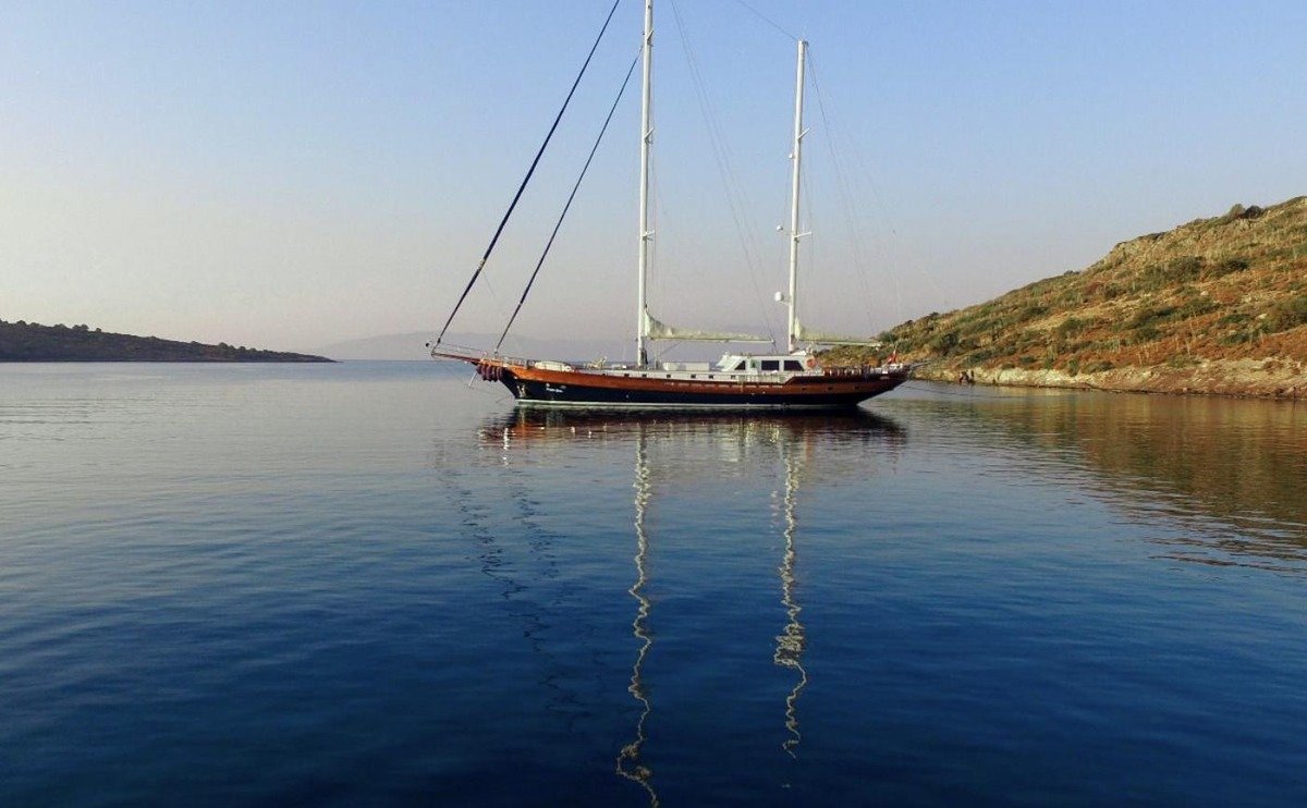 Luxury gulet charter Greece — the 34 metre gulet at anchor on glassy water at dusk