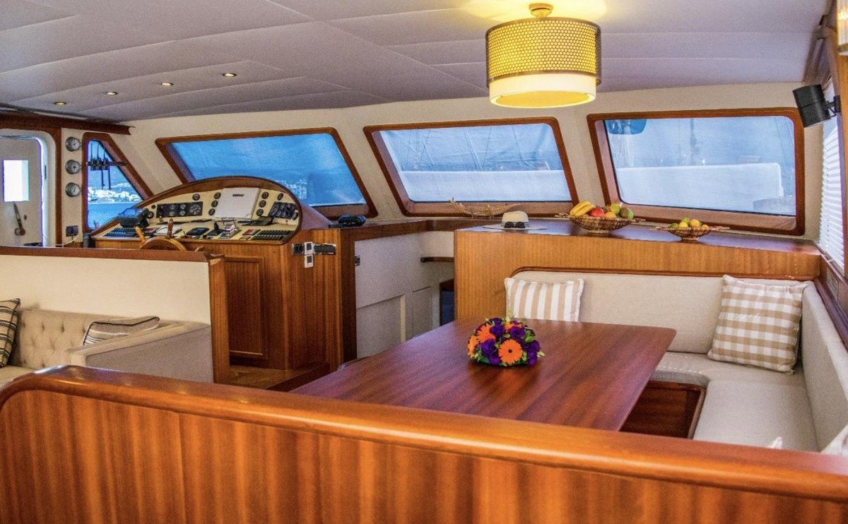 Saloon dining table and wheelhouse in mahogany