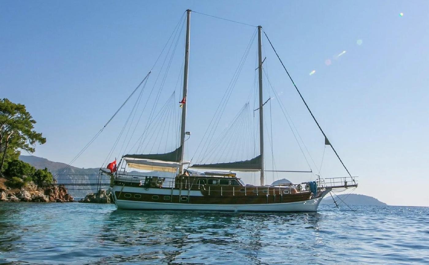 Broadside view of a luxury gulet charter Selimiye on glassy morning water